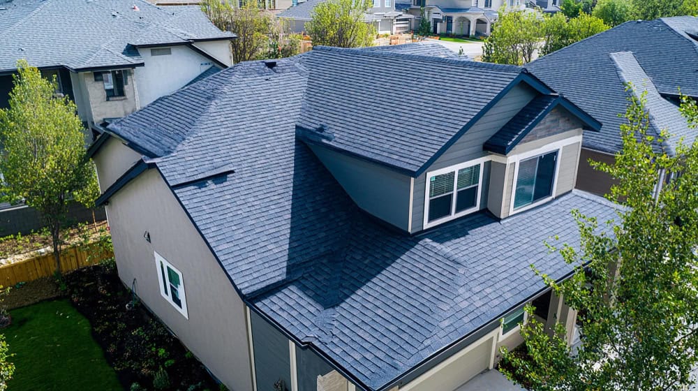Aerial view of a completed gray shingle roof replacement