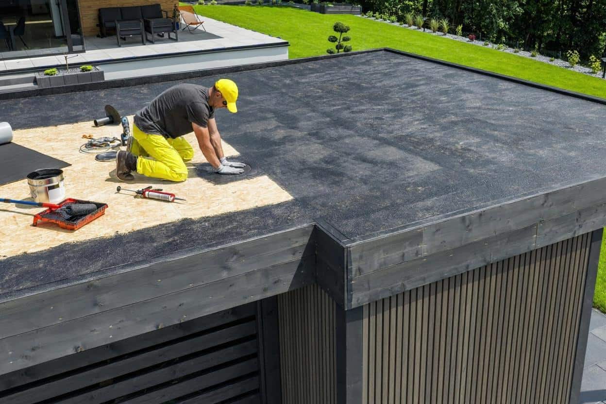 Crew installing a new roof membrane